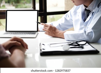 Doctor Using Computer Tablet Discussion Something With Patient. Health Care , Hospital And Doctor Concept.  Copy Space Of Blank Computer And Tablet Screen.