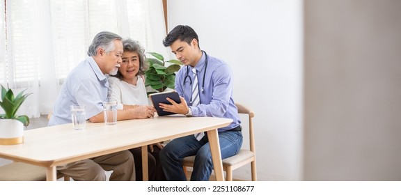 Doctor using digital tablet discussing test result and diagnosis to Asian grandma patient while old man take care of her, service Life insurance at home, healthcare with Long live and Elderly society - Powered by Shutterstock