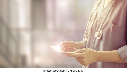 Doctor Using A Digital Tablet, Half Length Portrait Of A Female Physician In A Blurred Hospital Background, Concept Of Health Care Service Professionals