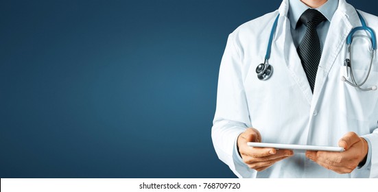 Doctor using digital tablet, modern technology in medicine and healthcare concept on blue background