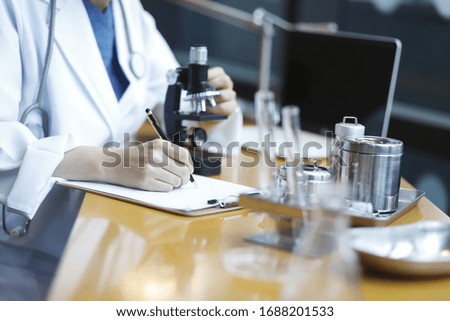 Doctor using microscope in laboratory