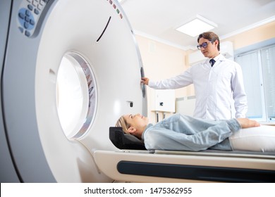 Doctor using MRI machine during patient examination stock photo. Medicine diagnostic concept
