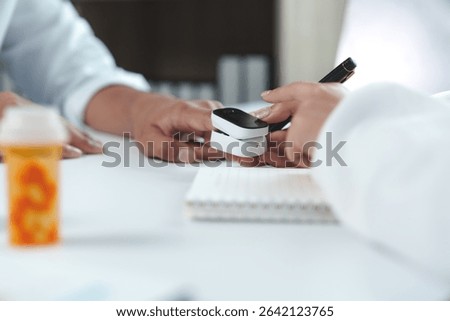 Doctor is using pulse oximeter device during medical examination measuring patient blood oxygen saturation