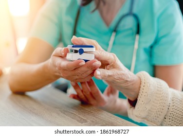 Doctor Using Pulse Oximeter On Woman