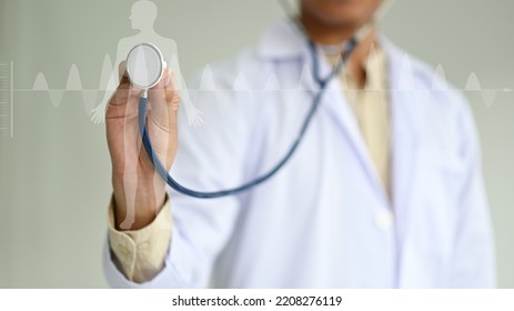 Doctor using stethoscope to check body and heart, human body hologram and electrocardiogram, medical concept. - Shutterstock ID 2208276119
