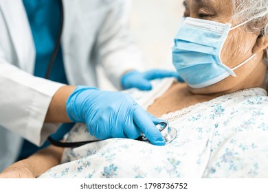 Doctor Using Stethoscope To Checking Asian Senior Or Elderly Old Lady Woman Patient Wearing A Face Mask In Hospital For Protect Infection And Kill Novel Coronavirus Covid-19 Virus.