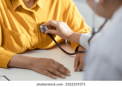 Doctor using a stethoscope checking patient stethoscope putting beat heart diagnose medical checkup cardiologist in examination room