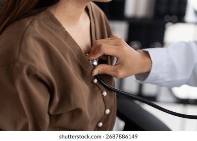 Doctor using a stethoscope checking patient stethoscope putting beat heart diagnose medical checkup cardiologist in examination room