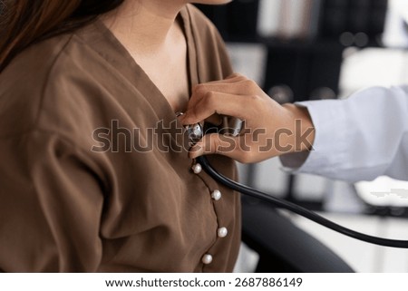 Doctor using a stethoscope checking patient stethoscope putting beat heart diagnose medical checkup cardiologist in examination room