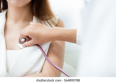 Doctor Using Stethoscope To Exam Woman Patient Heart