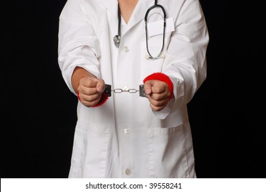 doctor using stethoscope and handcuffs to  debate health care reform - Shutterstock ID 39558241