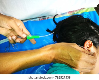 Doctor Is Using Suction Tool For Ear Wax