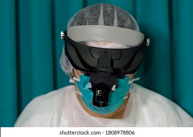 Doctor Using A Surgical Headlamp On Her Head