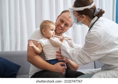 Doctor Using Tongue Depressor To Check Baby Throat