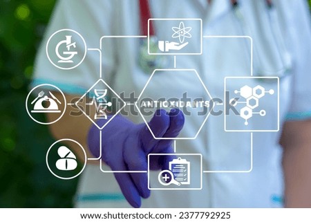 Doctor using virtual touch interface presses word: ANTIOXIDANTS. Natural Antioxidant Nutrition Healthy Eating Diet Medical Concept. Healthy foods rich in antioxidants. 商業照片 © 