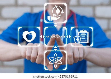Doctor using virtual touch screen presses text: ANTIOXIDANTS. Natural Antioxidant Nutrition Healthy Eating Diet Medical Concept. Healthy foods rich in antioxidants.
