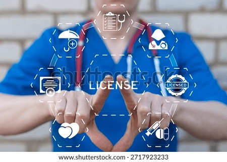 Doctor using virtual touch screen presses the word LICENSE. Health care license concept. Licensing pharmaceutical product, medical service, doctor, nurse.