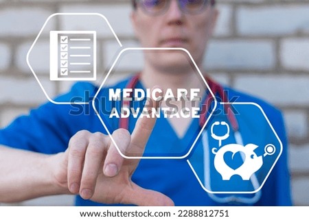Doctor using virtual touchscreen presses inscription: MEDICARE ADVANTAGE. Concept of medicare advantage. Health care insurance plan. Medicare benefits.