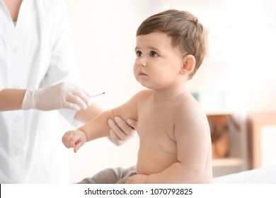 Doctor vaccinating baby in clinic - Powered by Shutterstock