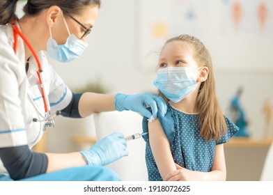 Doctor Vaccinating Child At Hospital.