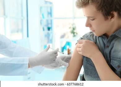 Doctor vaccinating patient in clinic - Powered by Shutterstock