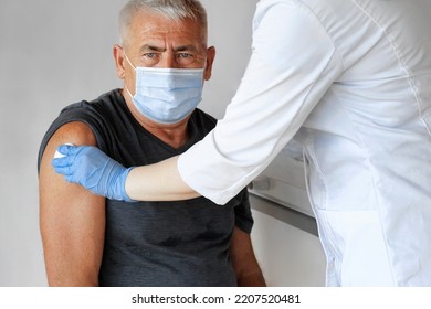 Doctor Vaccinating Senior Man In Clinic. Older People Vaccination. Doctor Giving Monkeypox Or COVID Vaccine Injection To Mature Man In Face Mask. Protection Of Elderly Patient. Old Man In Hospital