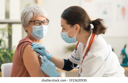 Doctor Vaccinating A Senior Woman. Virus Protection. COVID-2019.