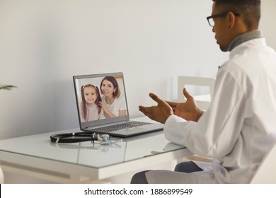 Doctor Video Calling Patients. Family Practitioner Or Pediatrician Sitting At Laptop Computer And Talking To Mother And Daughter. Telemedicine, EHealth Service And Virtual Medical Consultation Concept