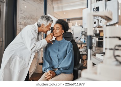 Doctor, vision or black woman in eye exam consultation or assessment for eyesight at optometrist office. Mature or senior optician helping a customer testing or checking iris or retina visual health - Powered by Shutterstock