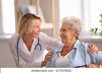 Doctor visiting senior woman at home