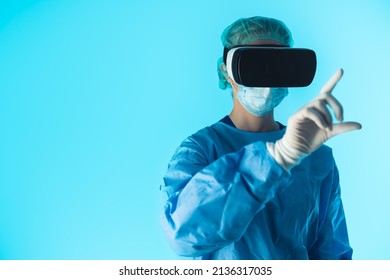 Doctor With Vr Glasses And Full Protective Uniform Touching Air With Finger. Modern Technology Concept. High Quality Photo