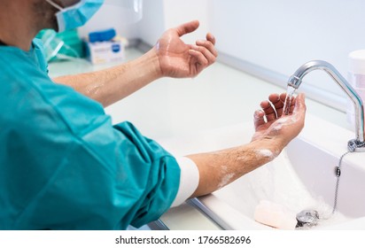 Doctor washing his hands before operating inside private clinic - Medical worker inside hospital - Health care and hygiene concept - Focus on right hand - Powered by Shutterstock