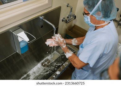 doctor washing his hands in the operating room. - Powered by Shutterstock