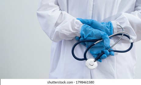 Doctor wear uniforms and gloves holding stethoscope to prepare for work during the spread of the coronavirus.Medical and Health care concept - Shutterstock ID 1798461580