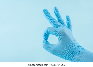 Doctor wearing blue gloves with OK gesture - Shutterstock ID 2035784666