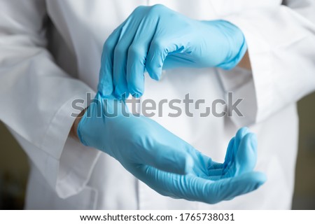 Doctor wearing blue nitrile gloves
