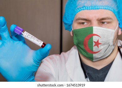 Doctor wearing face mask with flag Algeria holding a positive blood test result for the new rapidly spreading Coronavirus