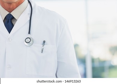 Doctor wearing lab coat in a bright office