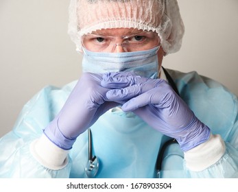 Doctor wearing mask and gloves intensely looks into the camera - Powered by Shutterstock