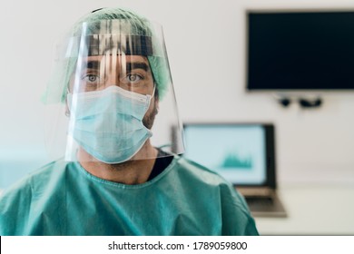 Doctor wearing ppe face surgical mask and visor fighting against corona virus outbreak - Health care and medical workers concept 