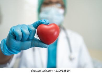 Doctor wearing ppe with mask for protect coronavirus holding red heart.