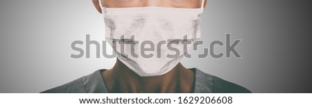 Doctor wearing protection face mask against coronavirus. Banner panorama medical staff preventive gear.