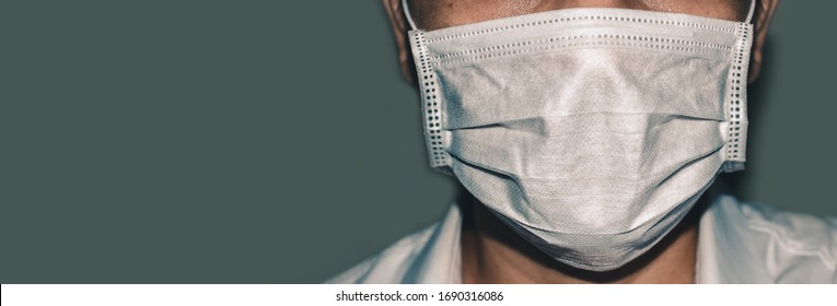 Doctor wearing protection mask against coronavirus, which are medical protective equipment, panorama images, text space. - Shutterstock ID 1690316086