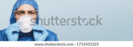 Doctor wearing protection Suit for Fighting Covid-19 (Corona virus) SARS infection Protective Equipment (PPE) with N95 or ffp3 mask, banner size, with copyspace for your individual text. Stock photo © 
