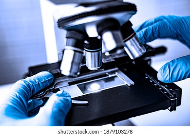 Doctor Wearing Protective Gloves Using Microscope Researching Corona Virus Microscopic Cells Testing Vaccination Cure, Medical Center Lab China Wuhan World Health Organization Research Facilities