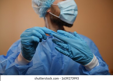 
The doctor is wearing a respiratory mask with a positive blood test for a new rapidly spreading coronavirus originating from Wuhan, China.The doctor takes off the glove.