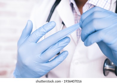 doctor wears medical latex gloves, close up