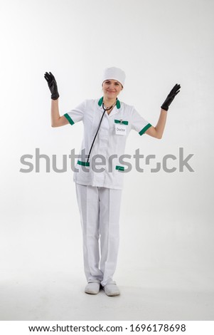 Doctor in a white coat puts on gloves