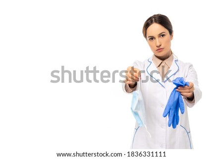 Doctor in white coat showing medial mask and latex gloves isolated on white