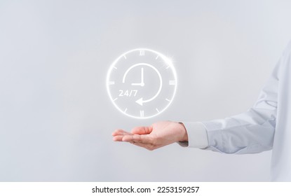 Doctor in a white coat uniform holding 24-7 service icon for assistance patient when accident or emergency, Medical call center service without interruption day and night. 